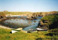 Fair Isle yoals in noosts at Kirki Geo, South Harbour.
